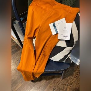 Brand new *with tags* Pumpkin/Fall orange Moto Leggings. Youth XL 14/16.